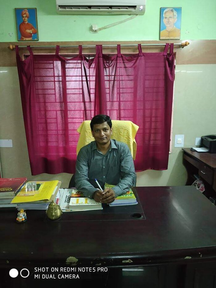 Mr. Manoranjan Mishra, Secretary, Smile Odisha, at his office desk